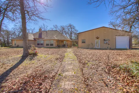 a view of large house with a yard and large tree