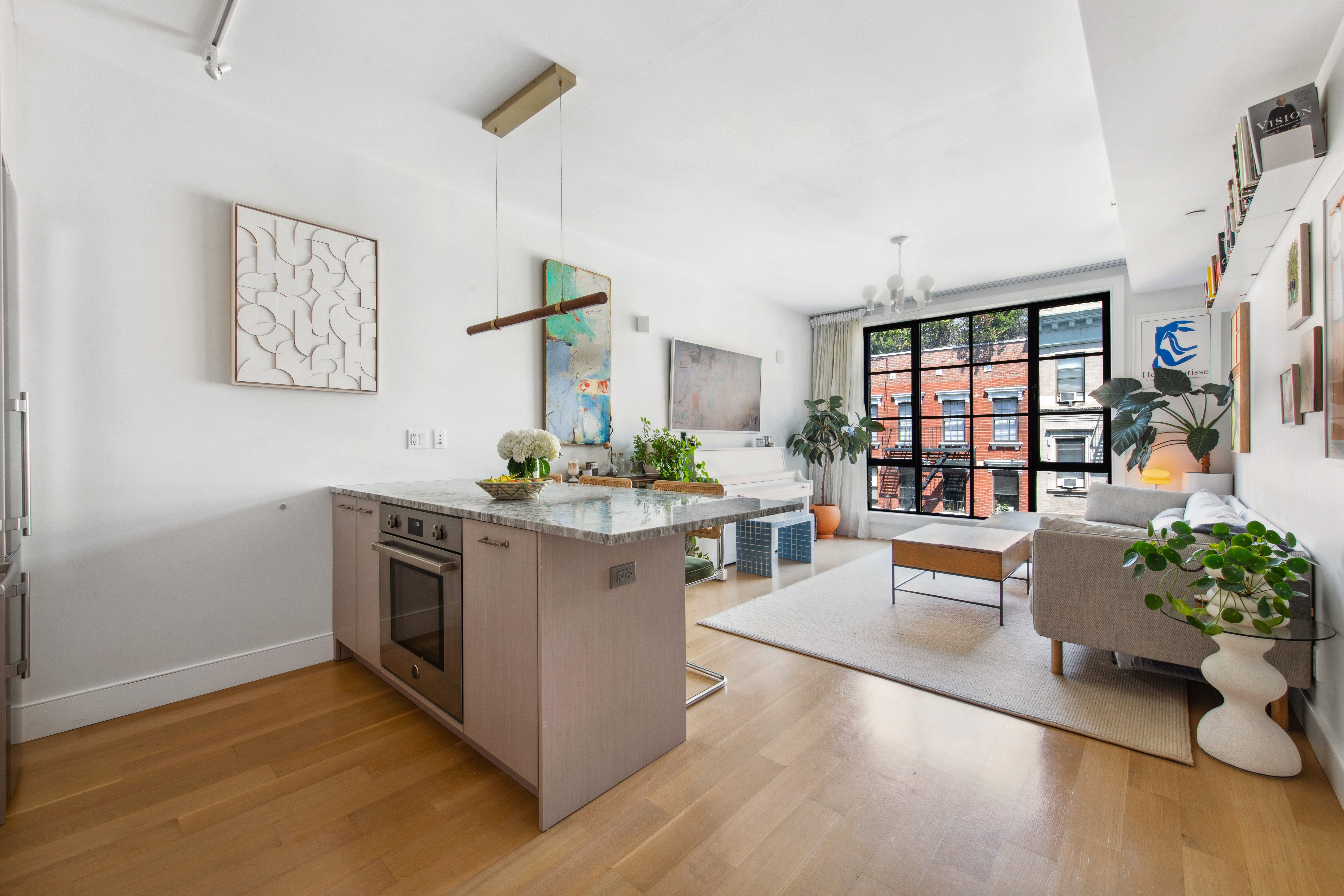 536 East 13th Street, Unit 5F Manhattan, NY 10009 - Photo 4 of 16 a living room with furniture and a wooden floor