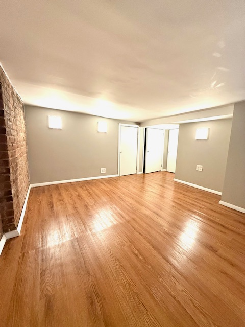 223 West 14th Street, Unit 1B Manhattan, NY 10011 - Photo 6 of 10 a view of an empty room and wooden floor