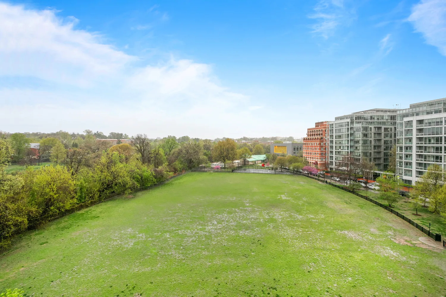 a view of a green field with lake view
