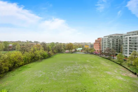 a view of a green field with lake view