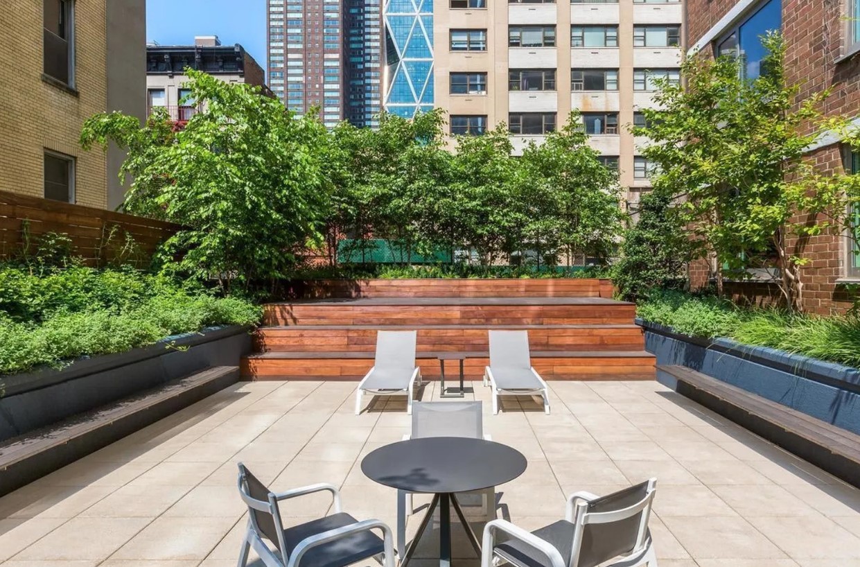 301 West 53rd Street, Unit 14C Manhattan, NY 10019 - Photo 11 of 12 a backyard of a house with seating space