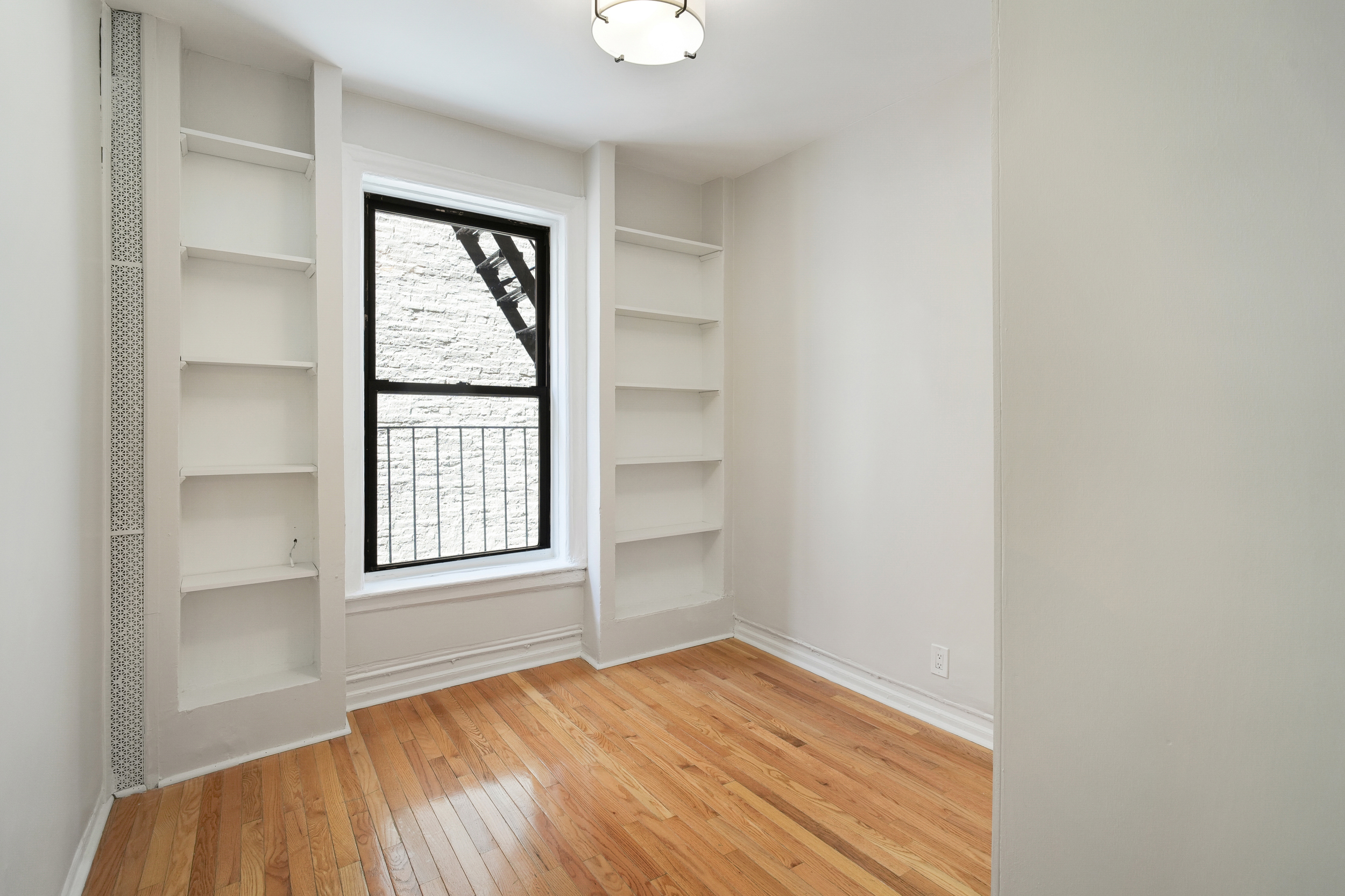 200 West 109th Street, Unit C1 Manhattan, NY 10025 - Photo 12 of 16 an empty room with windows and closet