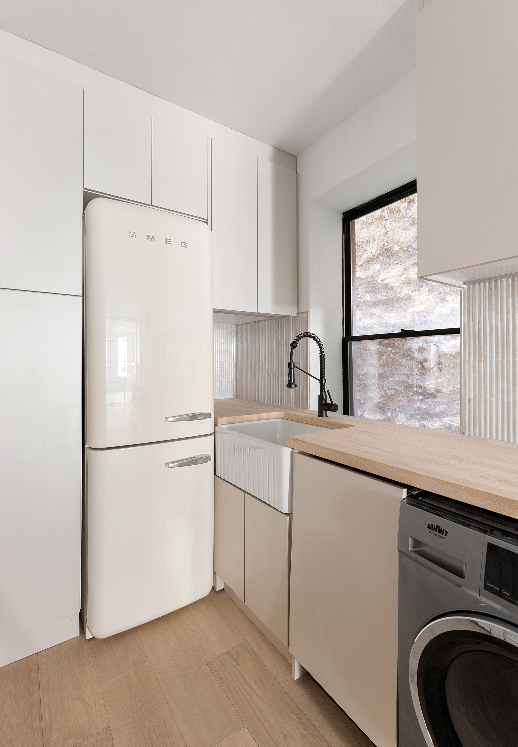228 West 16th Street, Unit 4B Manhattan, NY 10011 - Photo 4 of 9 a white refrigerator freezer sitting inside of a kitchen
