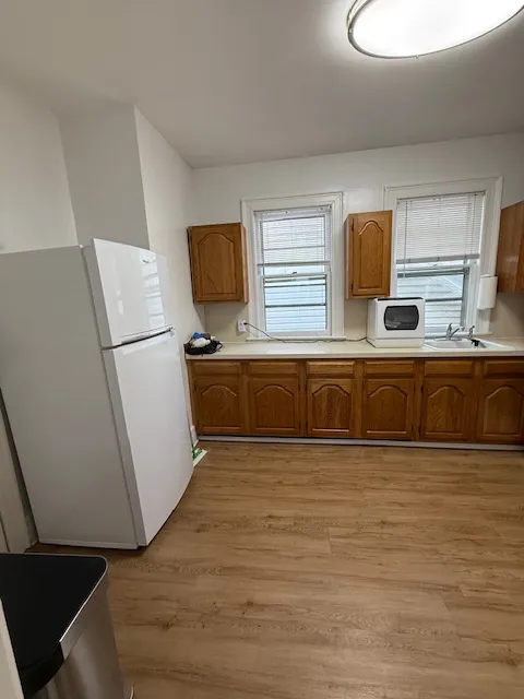 a kitchen with a stove a sink and a refrigerator