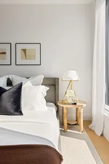 a spacious bedroom with a bed and a window