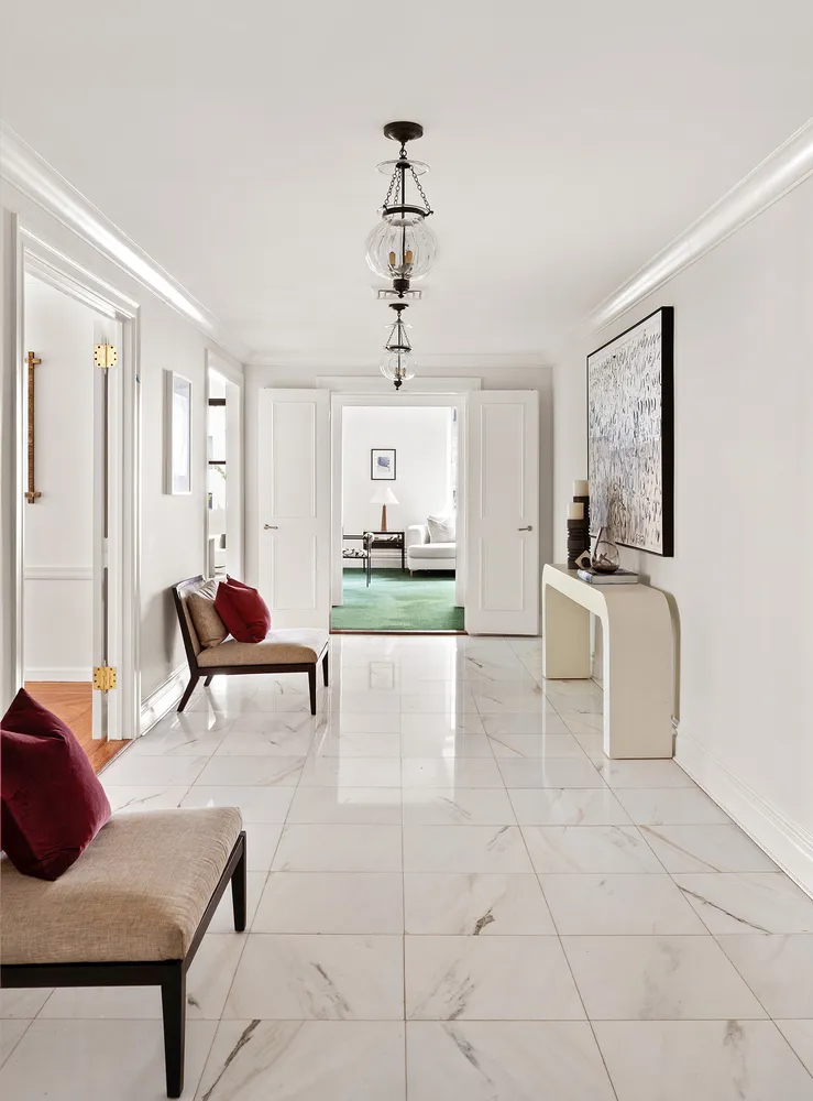 a living room with furniture and a floor to ceiling window