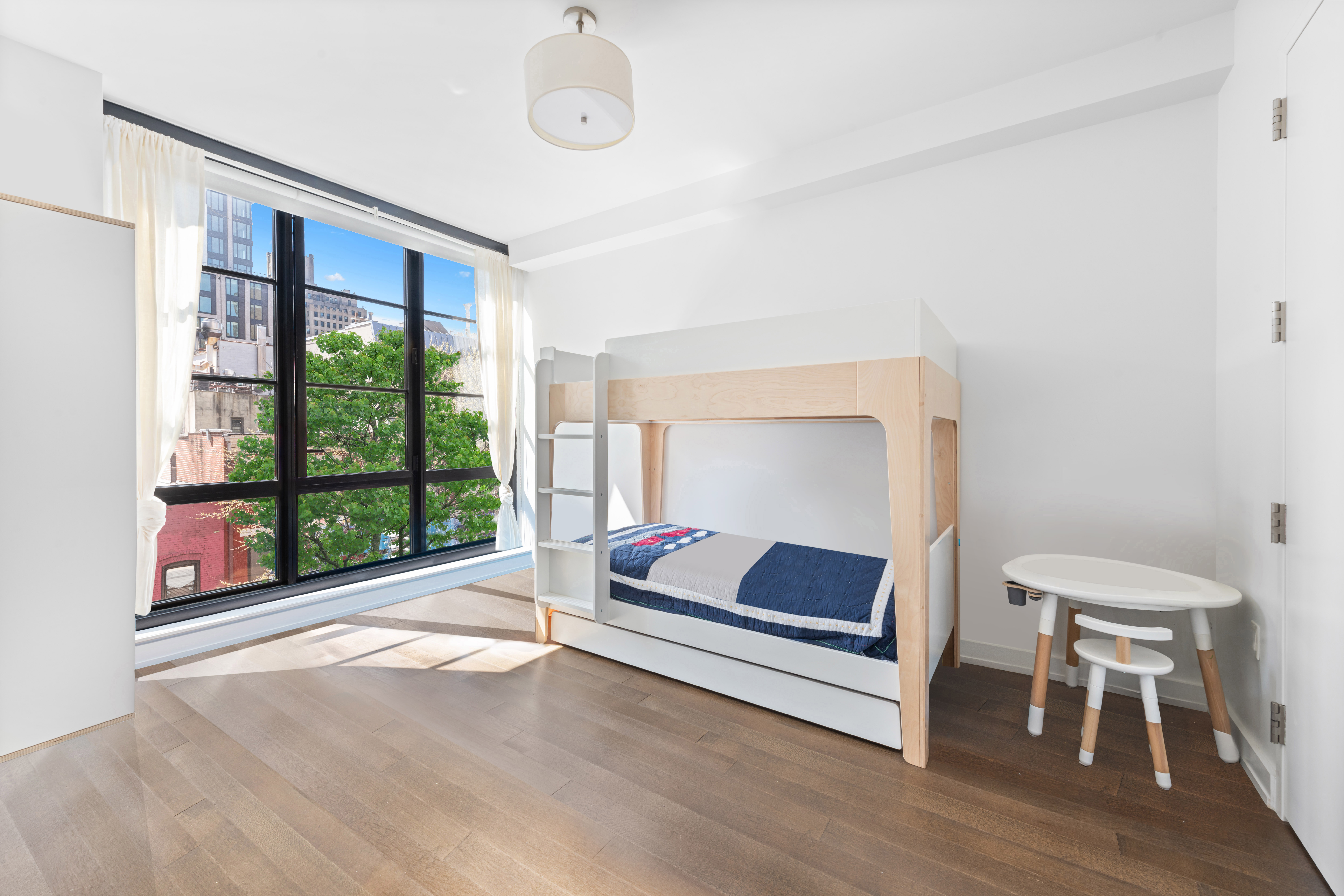 261 West 25th Street, Unit 4D Manhattan, NY 10001 - Photo 8 of 14 a room with furniture and windows