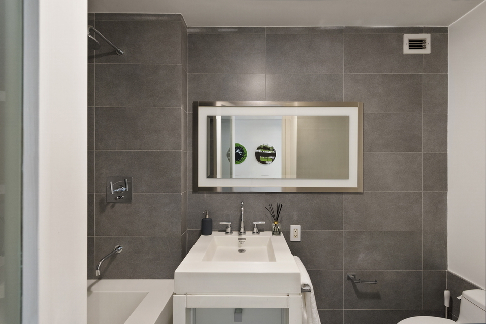 444 West 19th Street, Unit 201 Manhattan, NY 10011 - Photo 10 of 13 a bathroom with a sink a toilet and shower