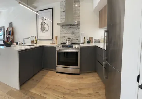 a kitchen with stainless steel appliances granite countertop a stove and a refrigerator