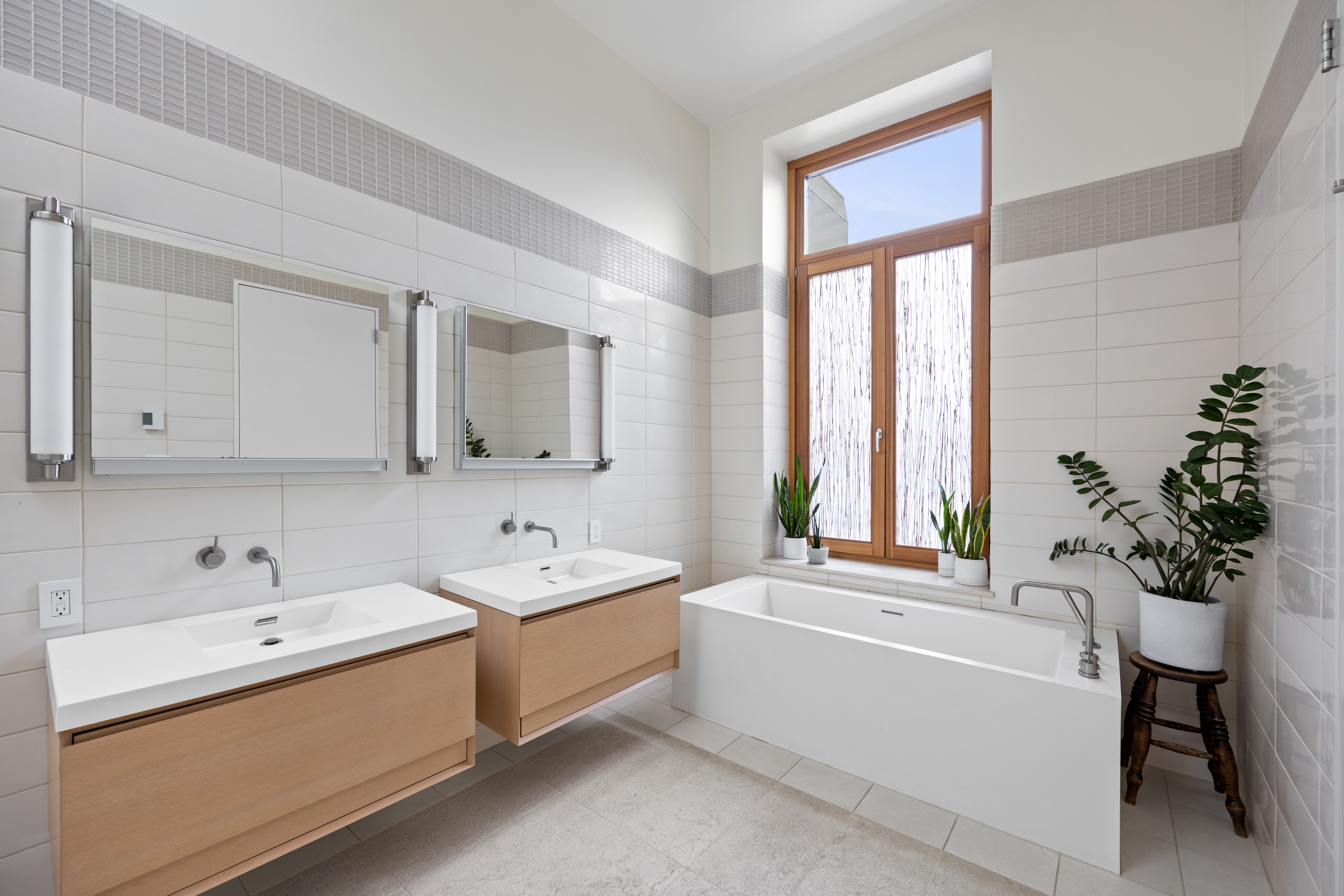 186 Franklin Street, Unit PHA Manhattan, NY 10013 - Photo 5 of 11 a bathroom with a bathtub a sink and a window