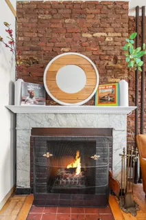 a fireplace with a clock on wall