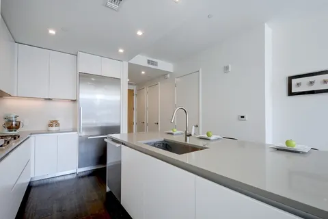 a kitchen with stainless steel appliances a sink stove and refrigerator