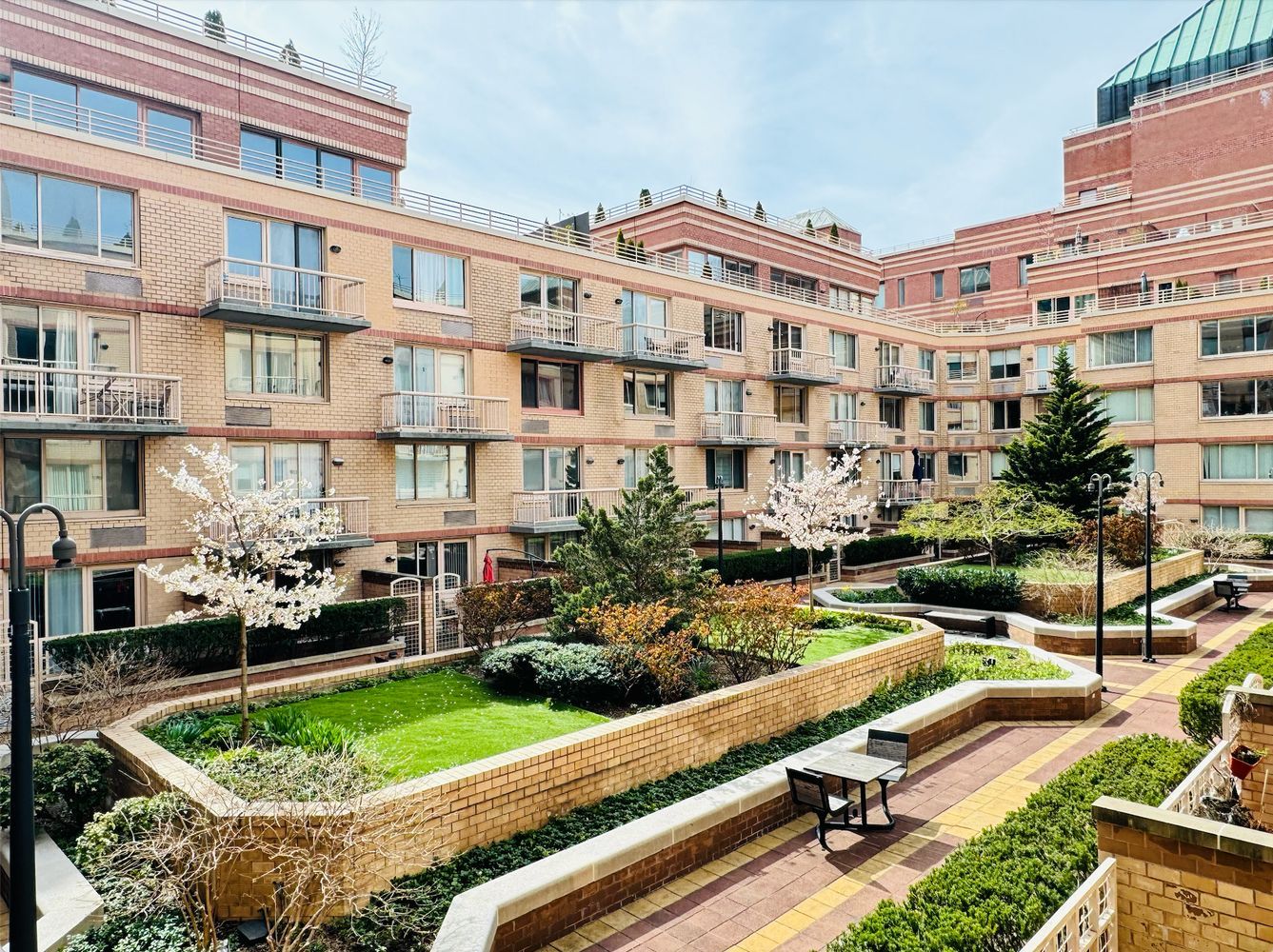 a front view of a building with garden and porch