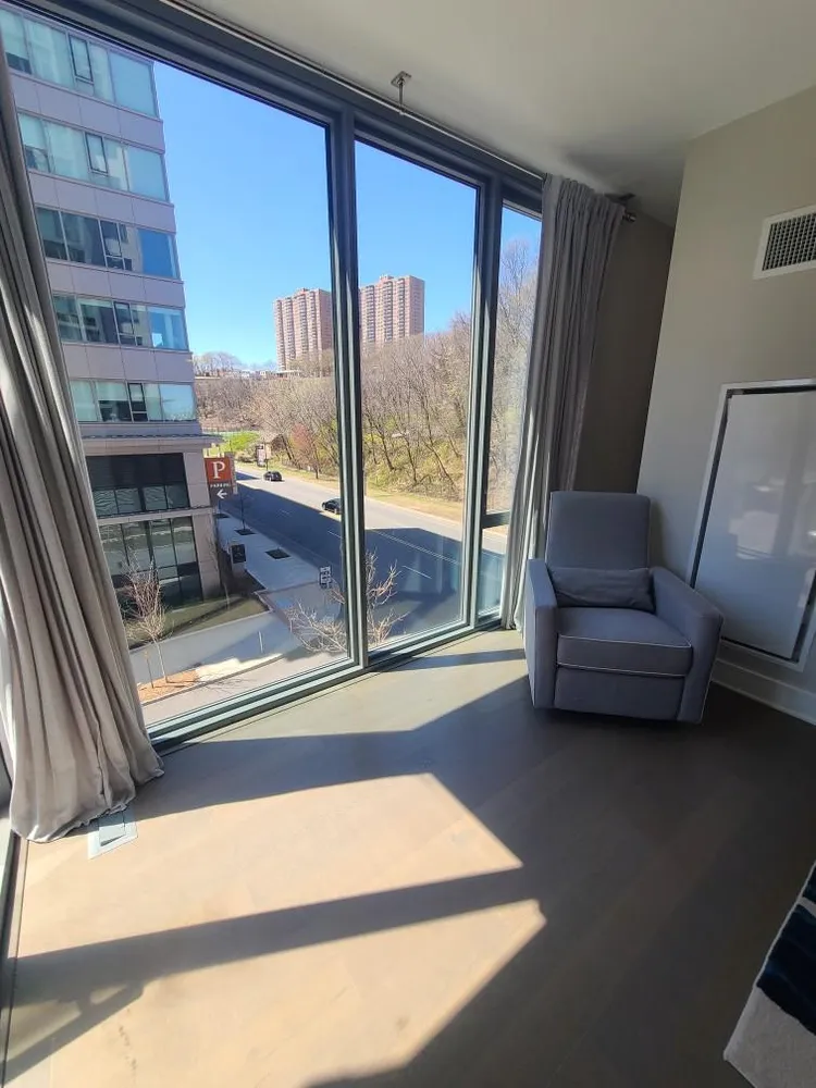a living room with a large window and a couch
