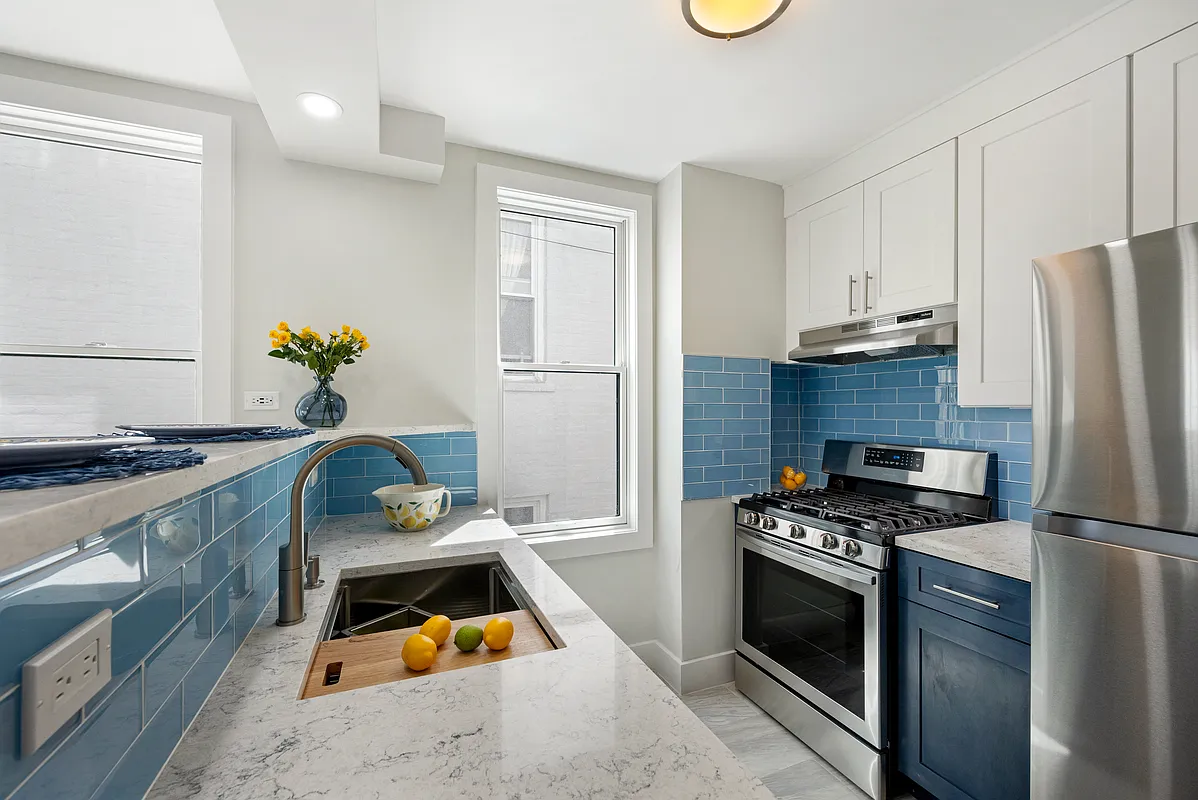 23-05 24th Avenue, Unit PHB Queens, NY 11102 - Photo 2 of 9 a kitchen with a stove and a refrigerator