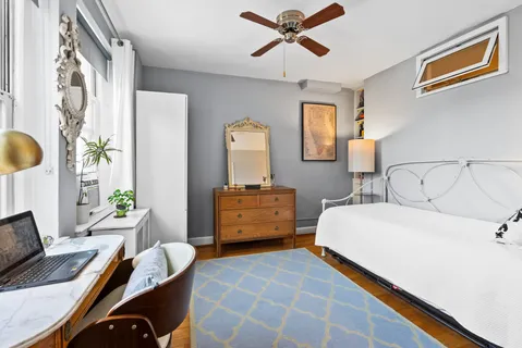 a bedroom with a bed a table and a chandelier