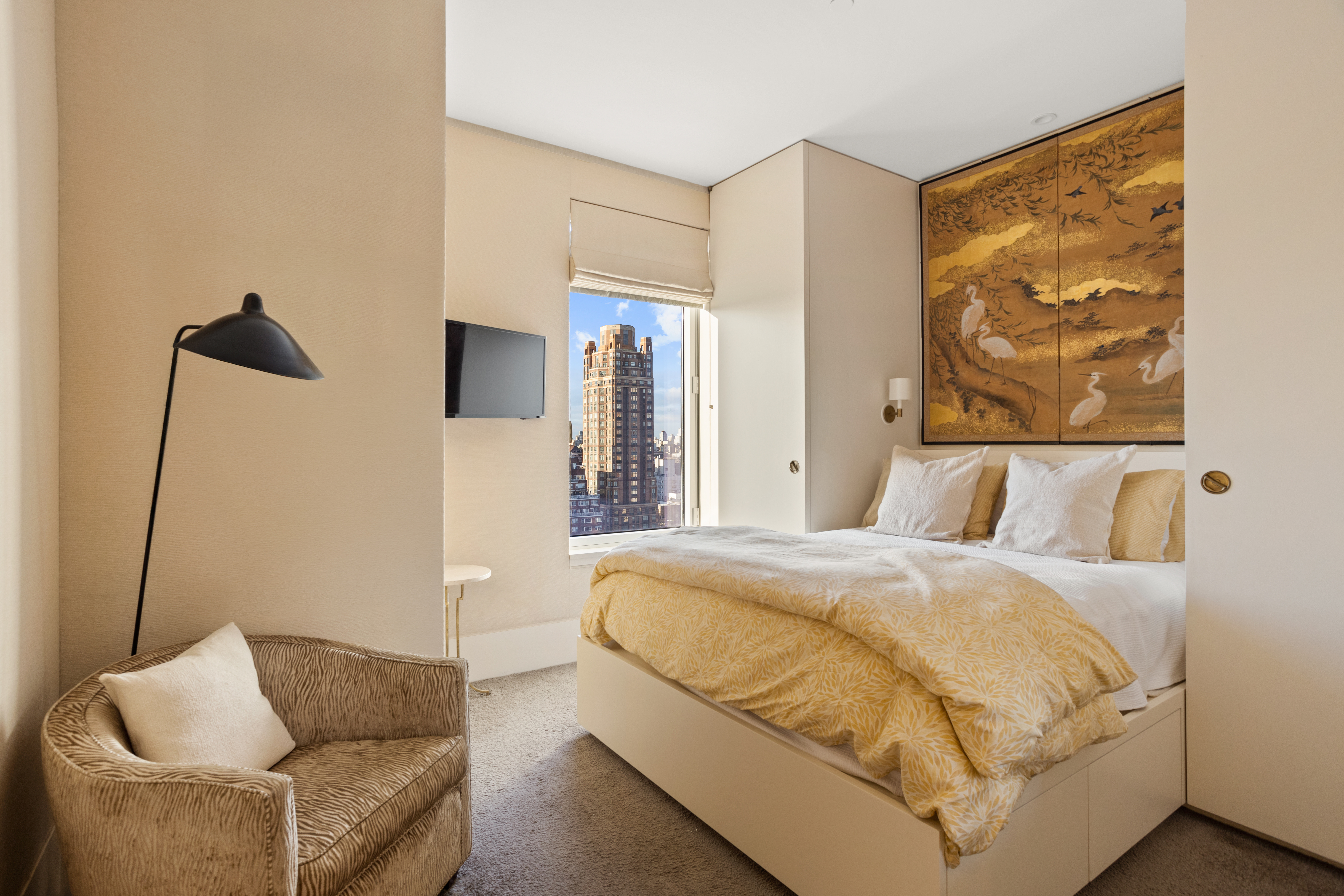 255 East 74th Street, Unit 21AB Manhattan, NY 10021 - Photo 18 of 37 a bedroom with a bed and couch