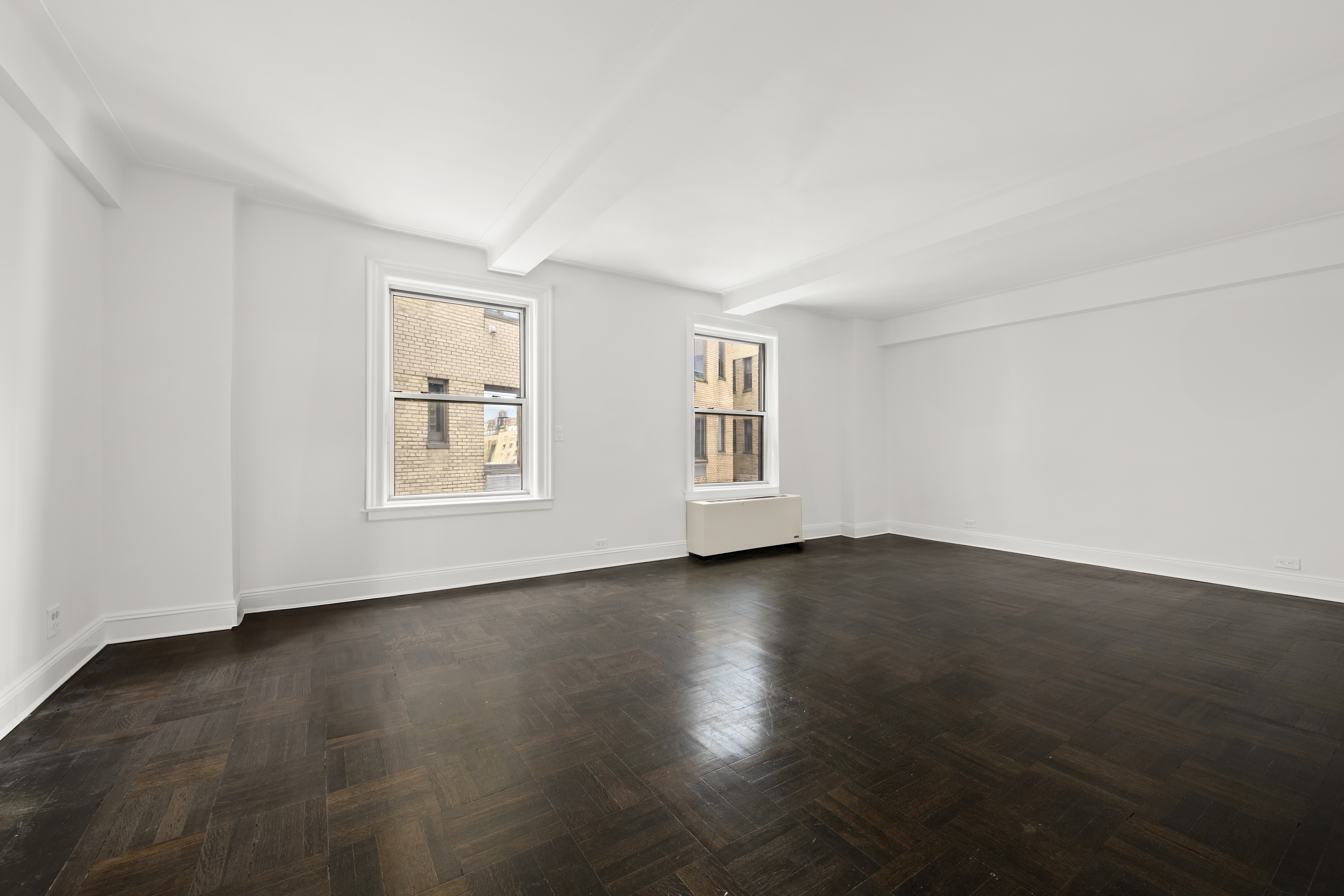 110-118 Riverside Drive, Unit 15C Manhattan, NY 10024 - Photo 1 of 6 a view of an empty room with wooden floor and windows