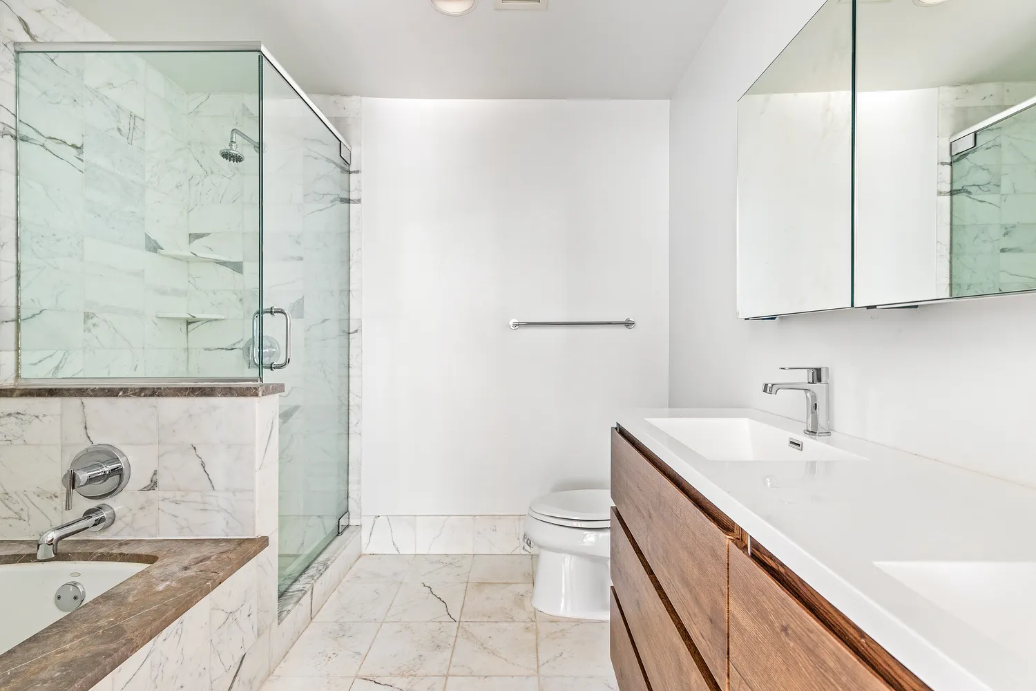 a bathroom with a granite countertop sink a toilet and shower
