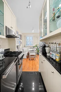a kitchen with stainless steel appliances a stove a sink and cabinets
