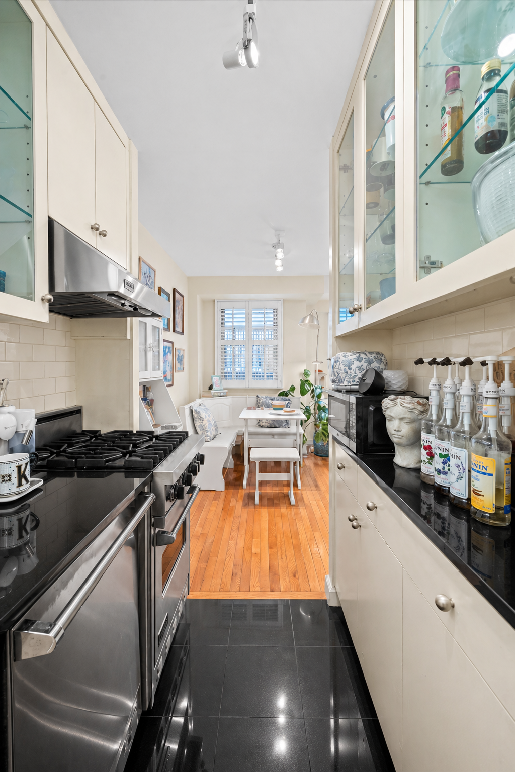 1175 York Avenue, Unit 1K Manhattan, NY 10065 - Photo 3 of 10 a kitchen with stainless steel appliances a stove a sink and cabinets