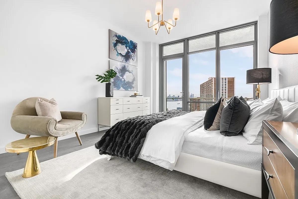 320 Adolphus Avenue, Unit 907 Cliffside Park, NJ 07010 - Photo 6 of 29 a bedroom with a bed and chair with the potted plant