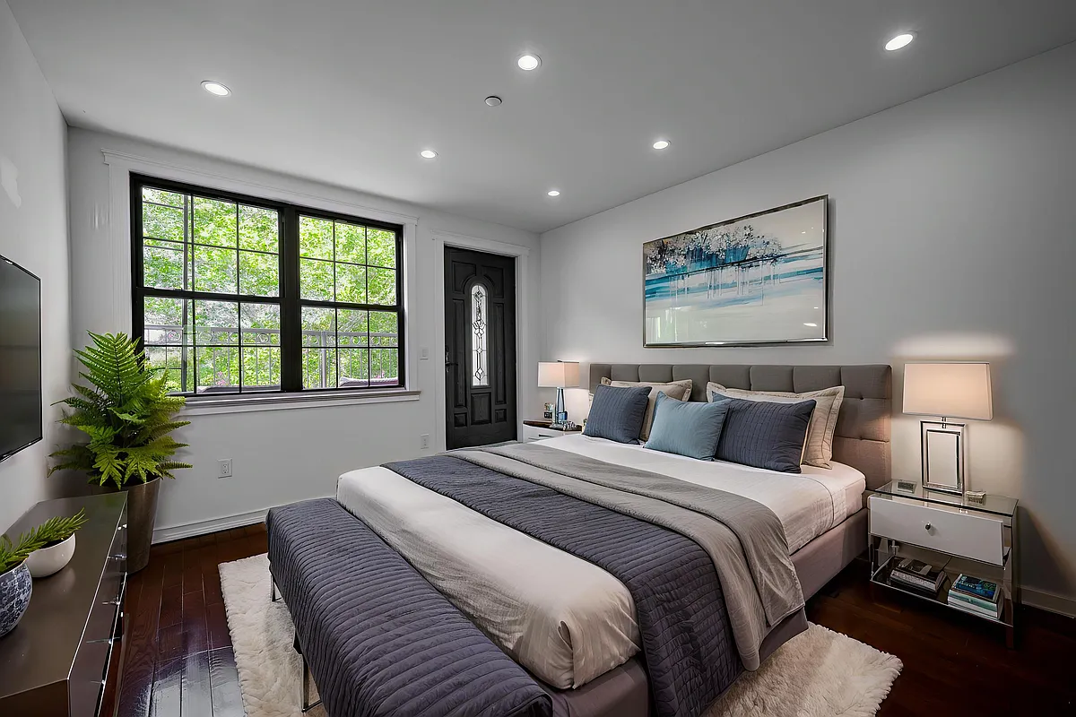 877 Greene Avenue, Unit 2 Brooklyn, NY 11221 - Photo 5 of 13 a bedroom with a large bed and a potted plant