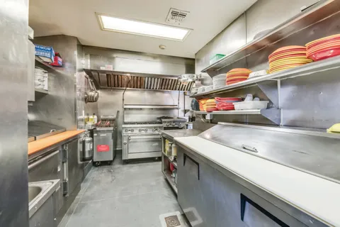 a kitchen with a refrigerator and a sink