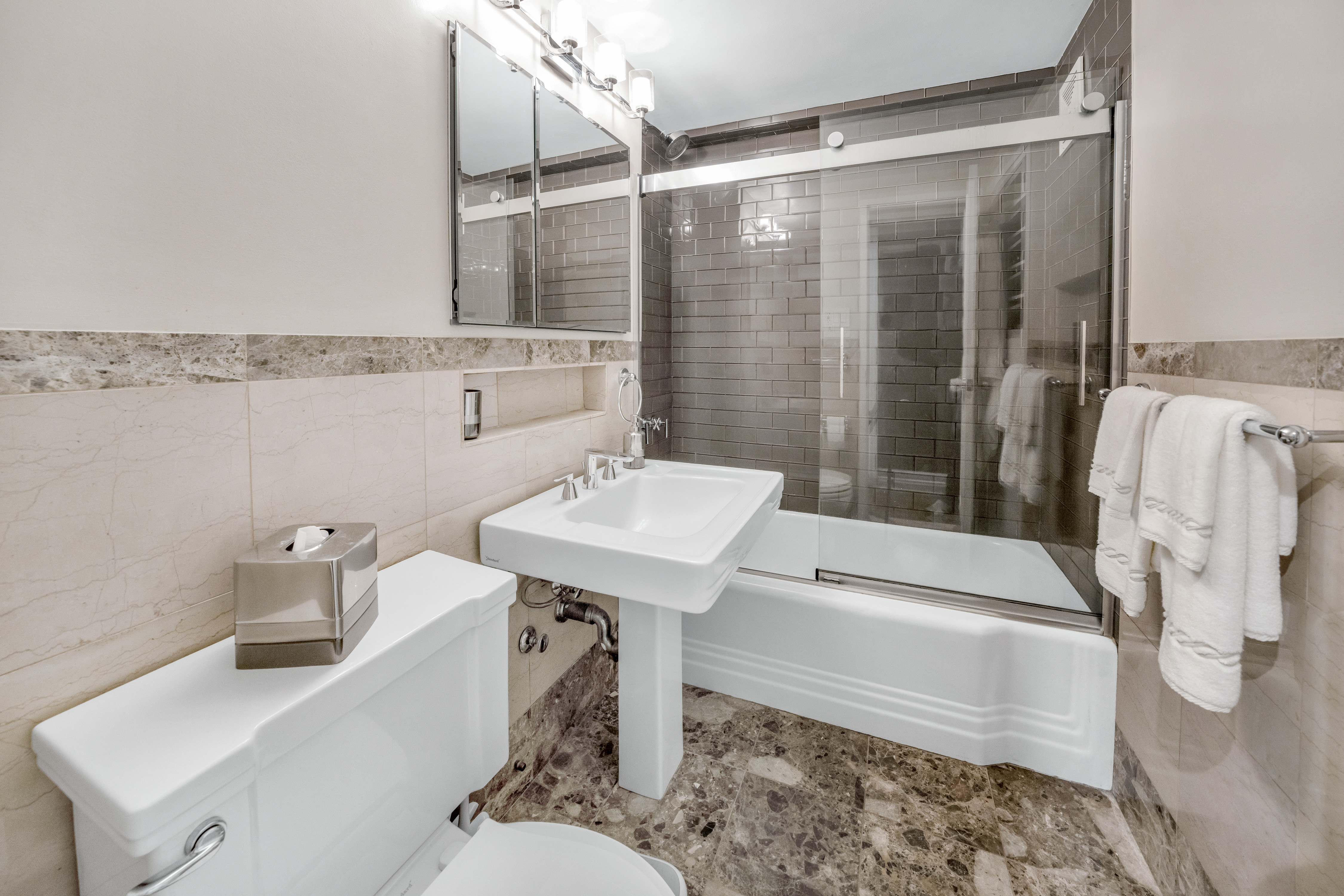 345 East 56th Street, Unit 11C Manhattan, NY 10022 - Photo 7 of 15 a bathroom with a sink and mirror with bathtub