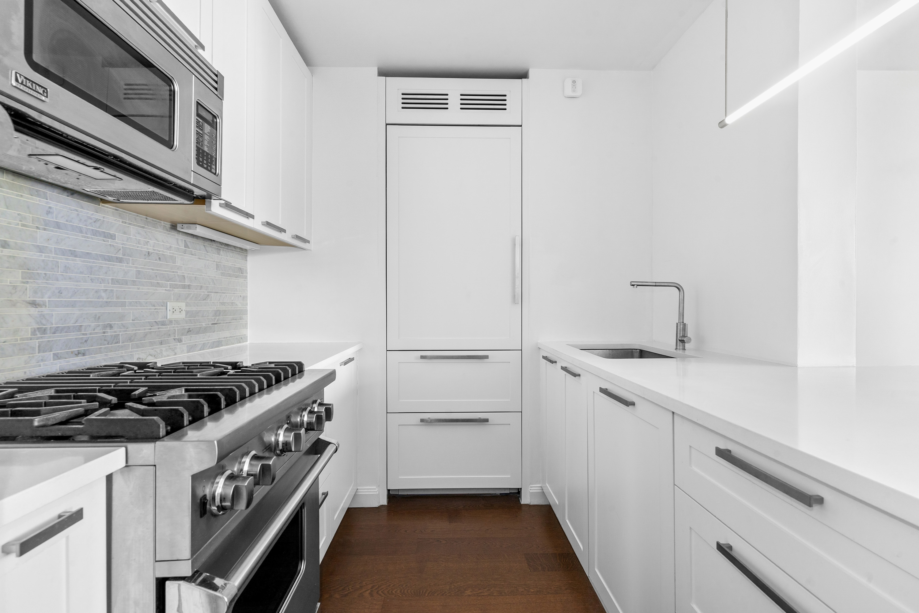200 East 94th Street, Unit 2911 Manhattan, NY 10128 - Photo 3 of 20 a kitchen with a sink stove and cabinets