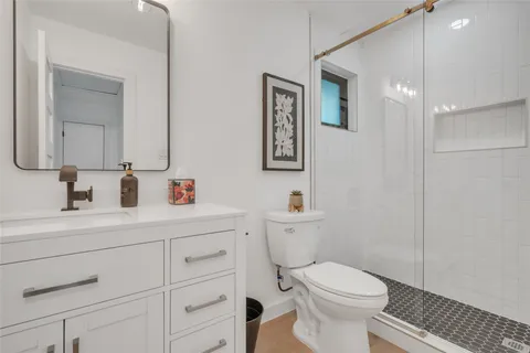 a bathroom with a toilet a sink and mirror