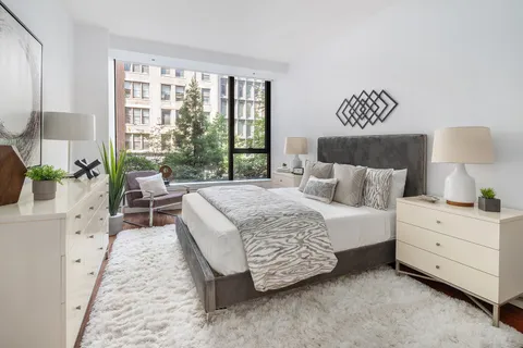 a bed room with a bed and a lamp
