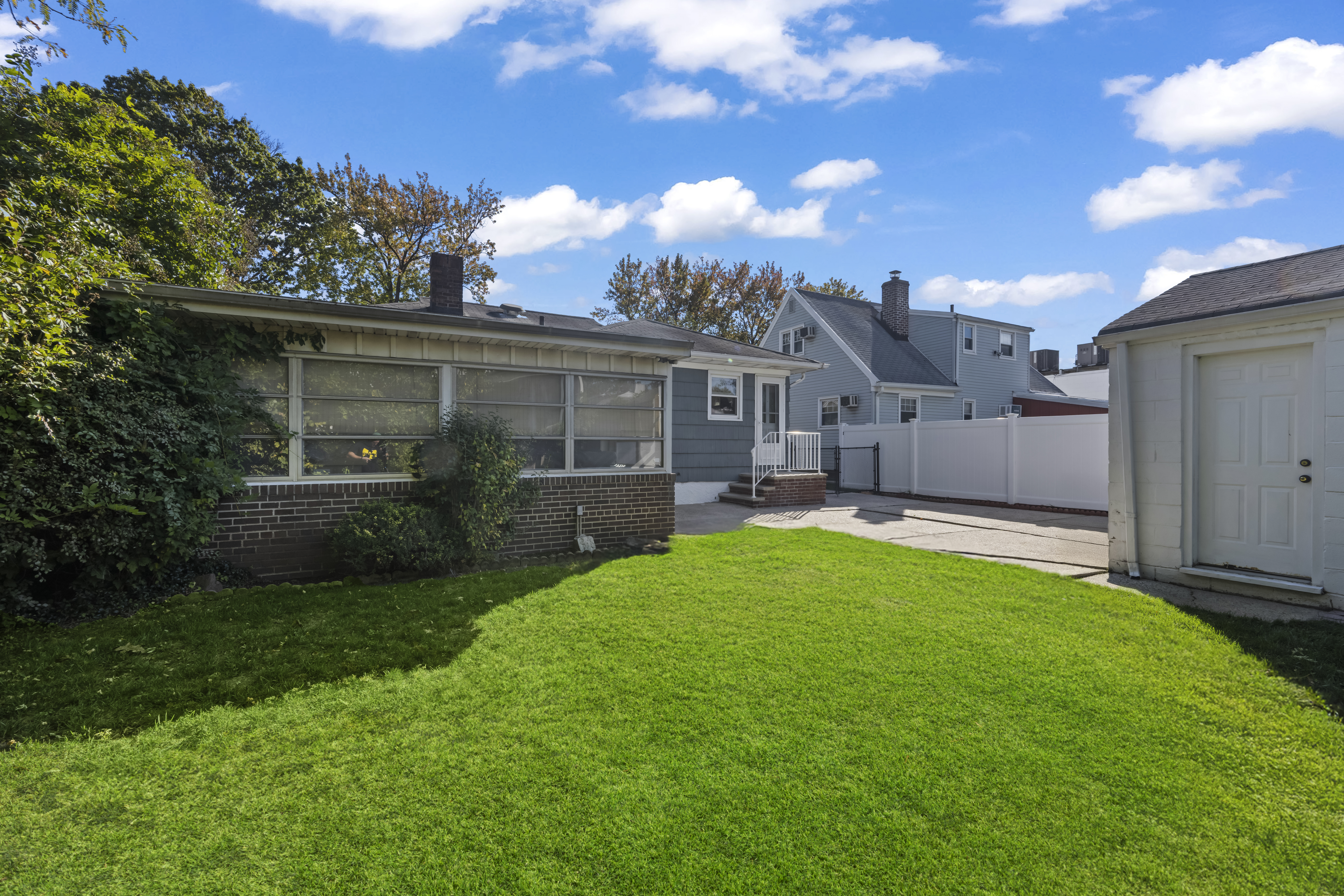 522 Stewart Avenue Staten Island, NY 10314 - Photo 28 of 33 a view of a house with backyard and a tree