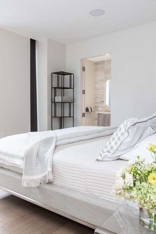 a bedroom with furniture and a flat screen tv