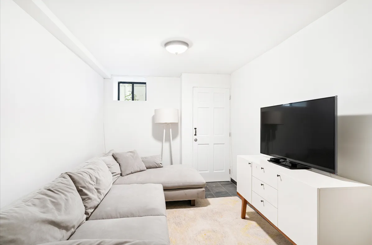 326 22nd Street, Unit 1R Brooklyn, NY 11215 - Photo 1 of 9 a living room with furniture and a flat screen tv