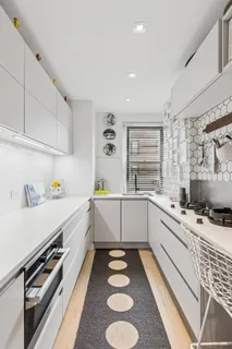 a kitchen with a sink stove and cabinets