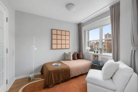 a bedroom with two beds and a large window