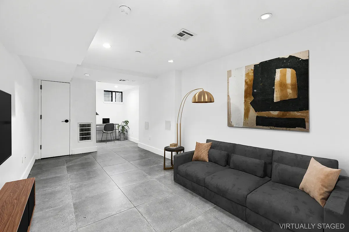 a living room with furniture and a mirror