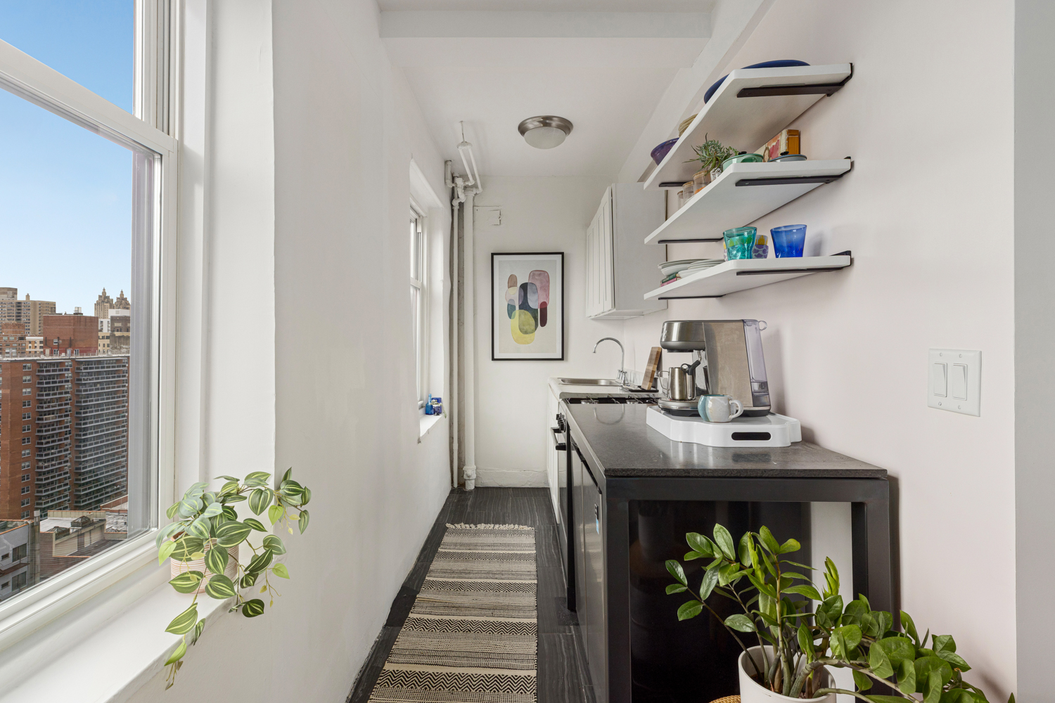 233 West 99th Street, Unit 19A Manhattan, NY 10025 - Photo 6 of 10 a dining room with furniture and a potted plant
