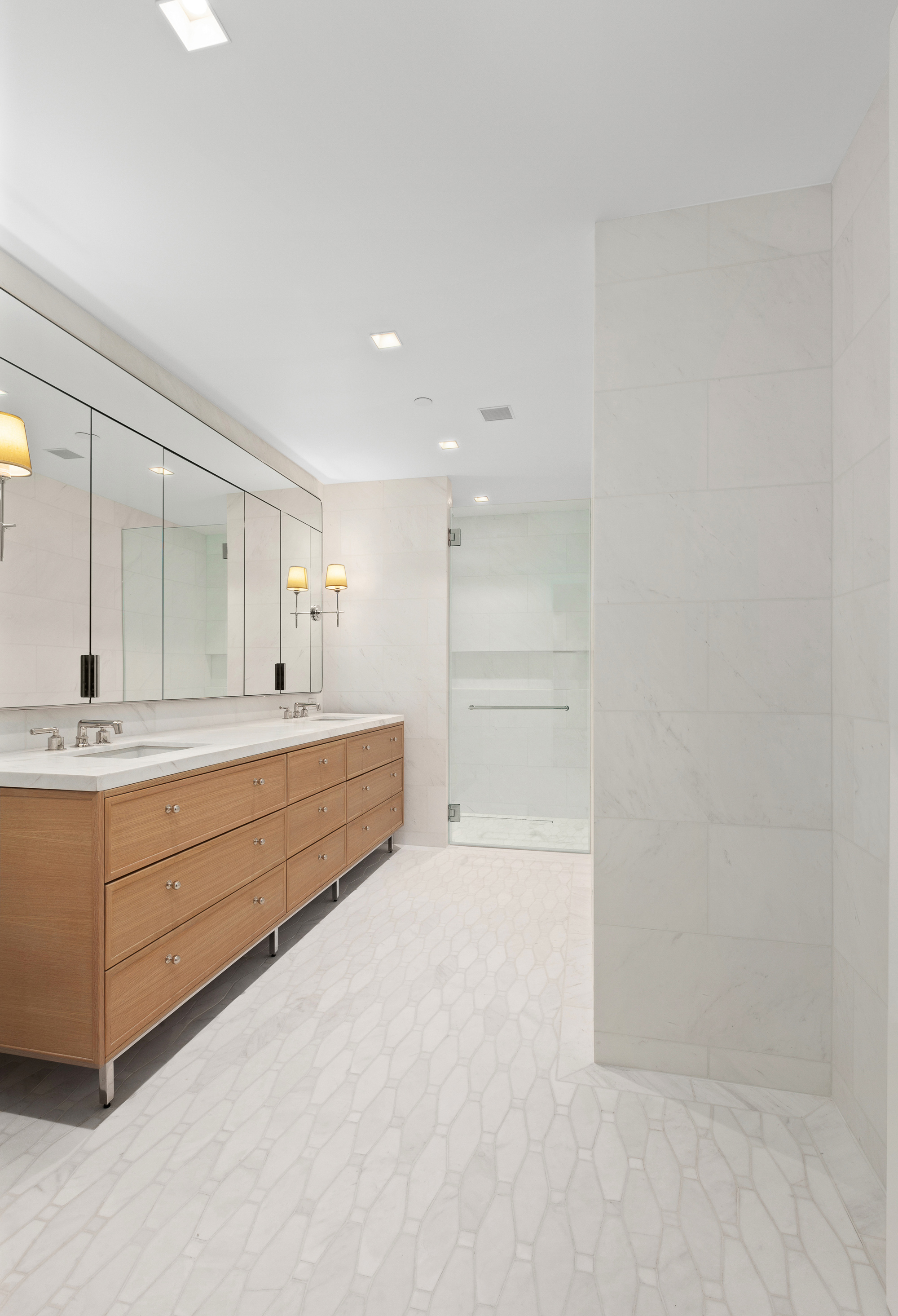 200 East 83rd Street, Unit 5D Manhattan, NY 10028 - Photo 11 of 29 a bathroom with a double vanity sink a mirror and a bathtub