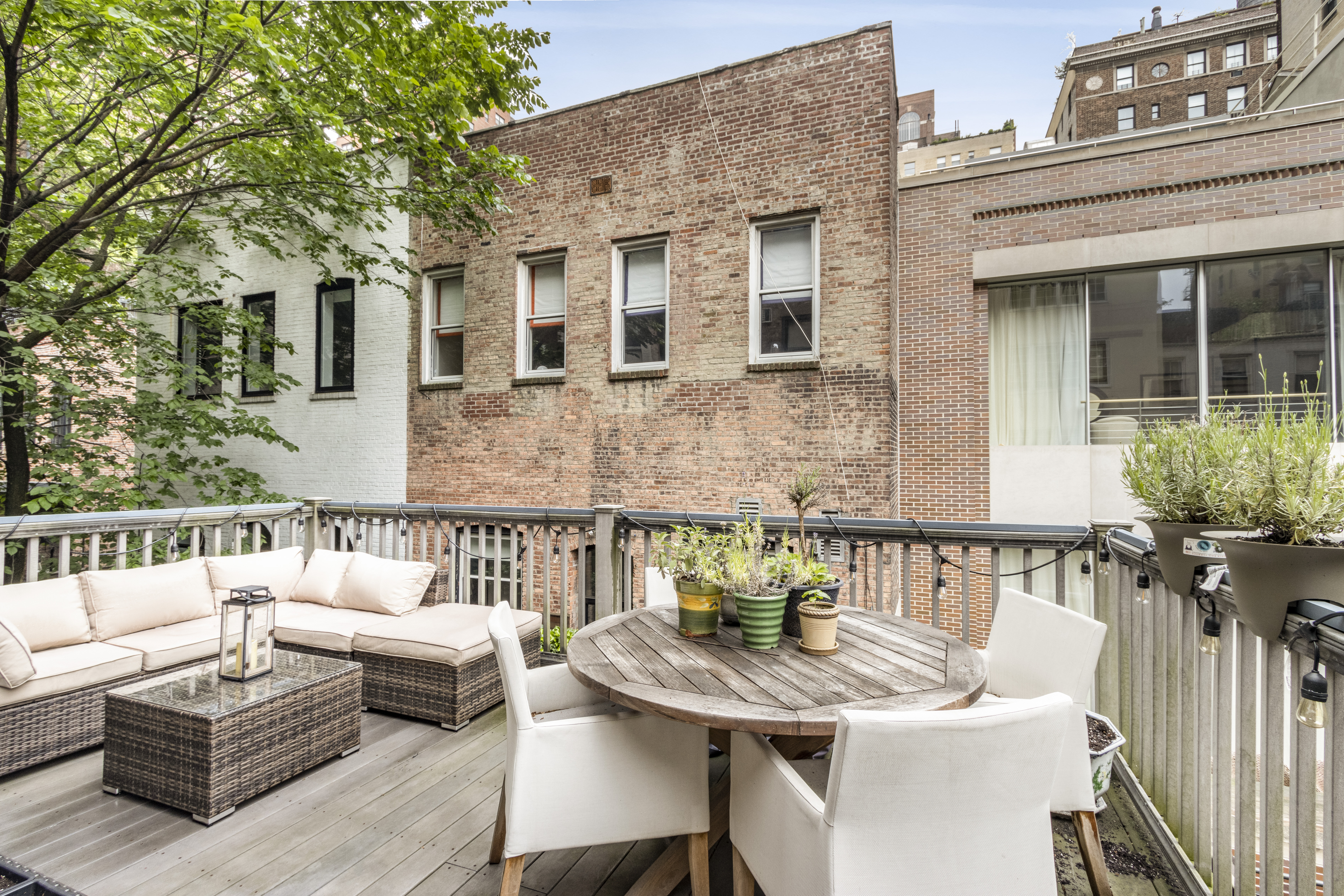 160 East 74th Street, Unit 3 Manhattan, NY 10021 - Photo 2 of 12 a view of a patio with couches table and chairs and potted plants