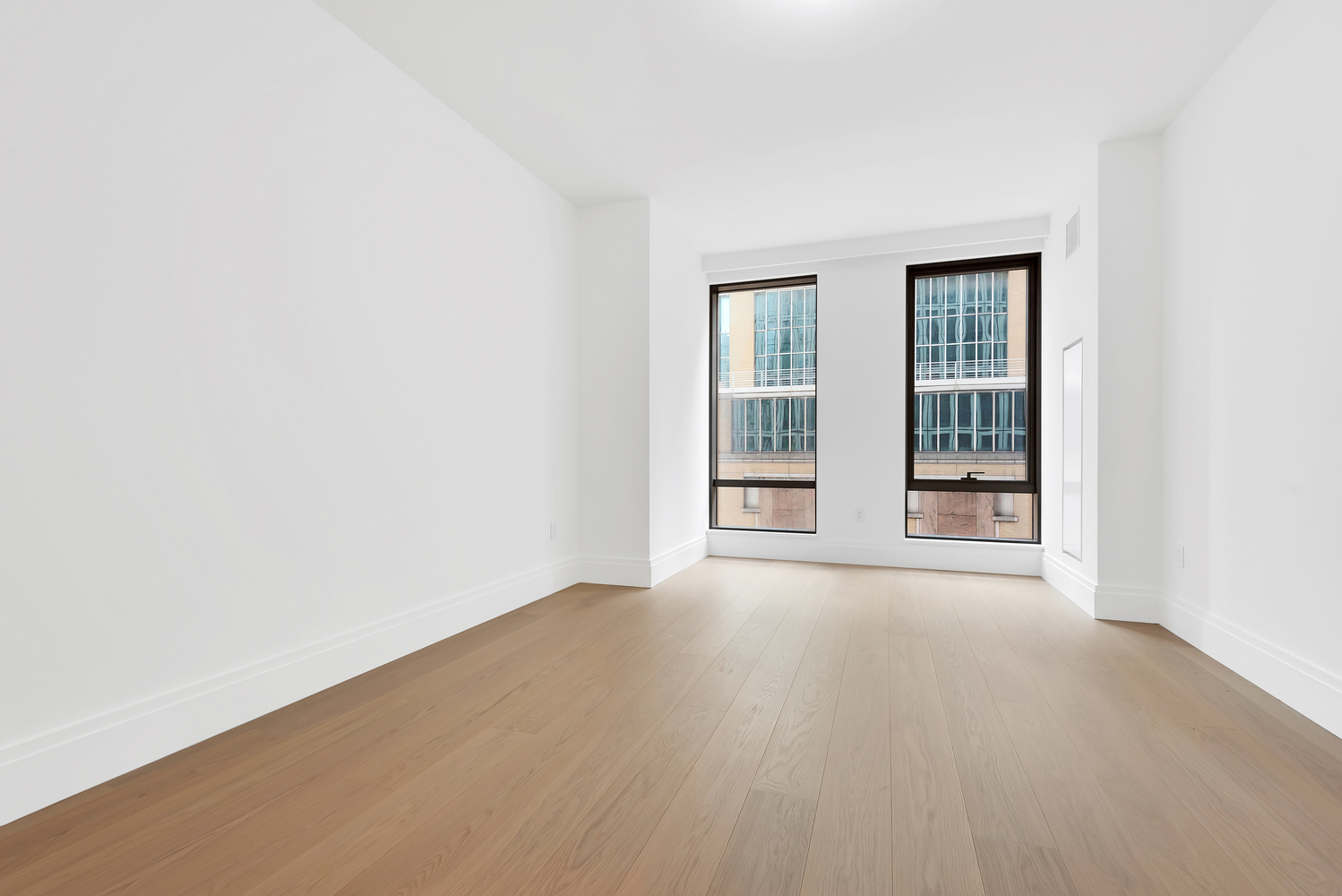 50 West 66th Street, Unit 7B Manhattan, NY 10023 - Photo 10 of 24 an empty room with wooden floor and windows