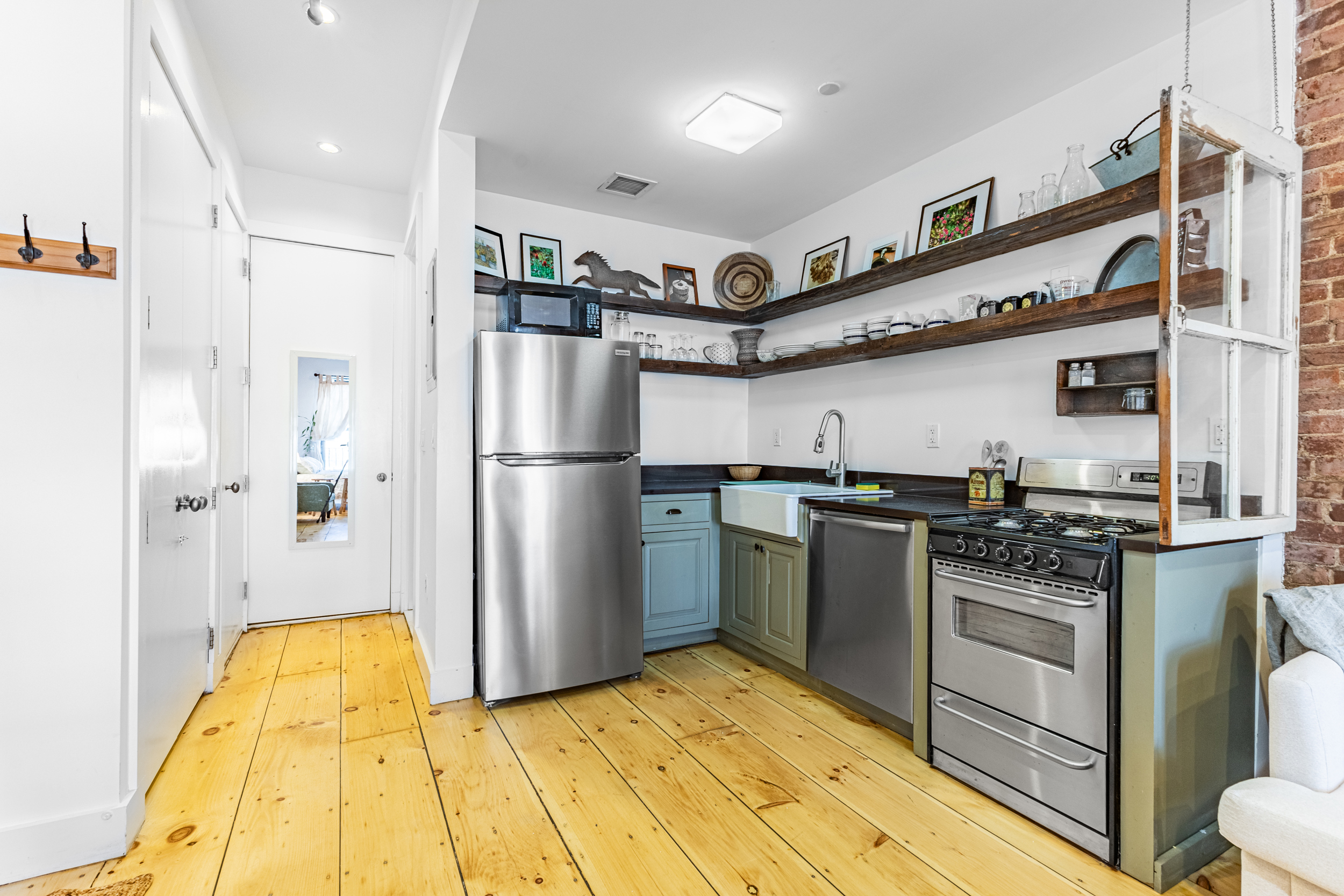 940 Fulton Street, Unit 3B Brooklyn, NY 11238 - Photo 6 of 18 a kitchen with stainless steel appliances granite countertop a refrigerator and a stove