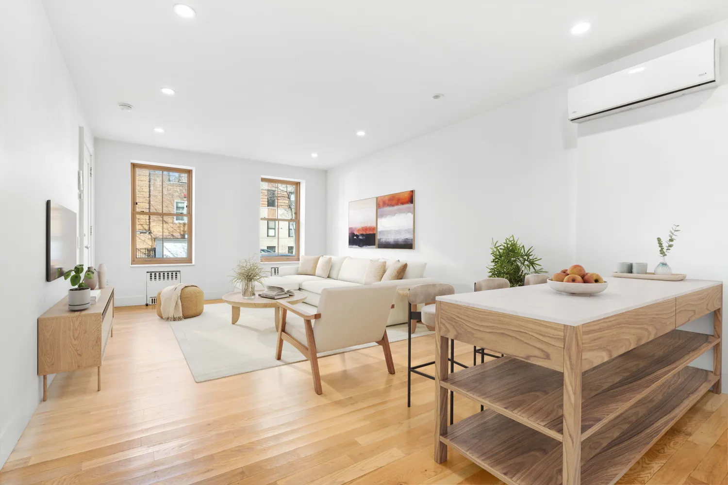 a living room with furniture and wooden floor