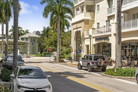a row of palm trees in front of a building