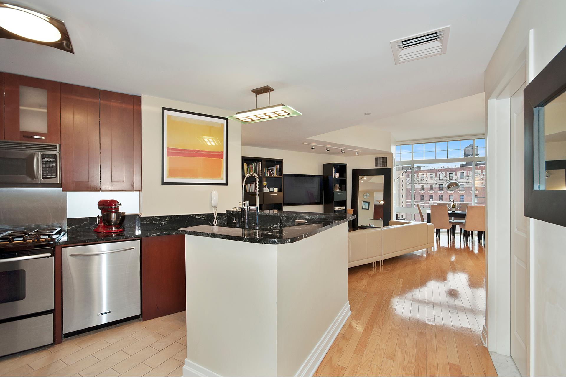 272 West 107th Street, Unit 15B Manhattan, NY 10025 - Photo 4 of 10 a kitchen with stainless steel appliances a sink a stove a refrigerator cabinets and living room view