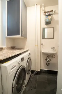 a utility room with sink dryer and washer