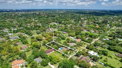 a view of backyard of house with green space
