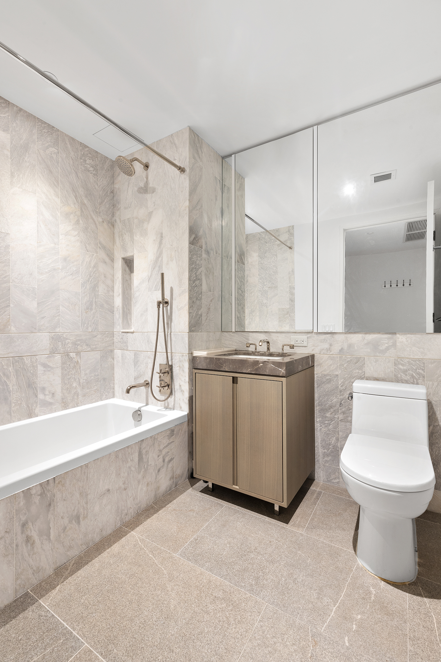 10 Nevins Street, Unit 5M Brooklyn, NY 11217 - Photo 4 of 7 a bathroom with a granite countertop sink a toilet and bathtub